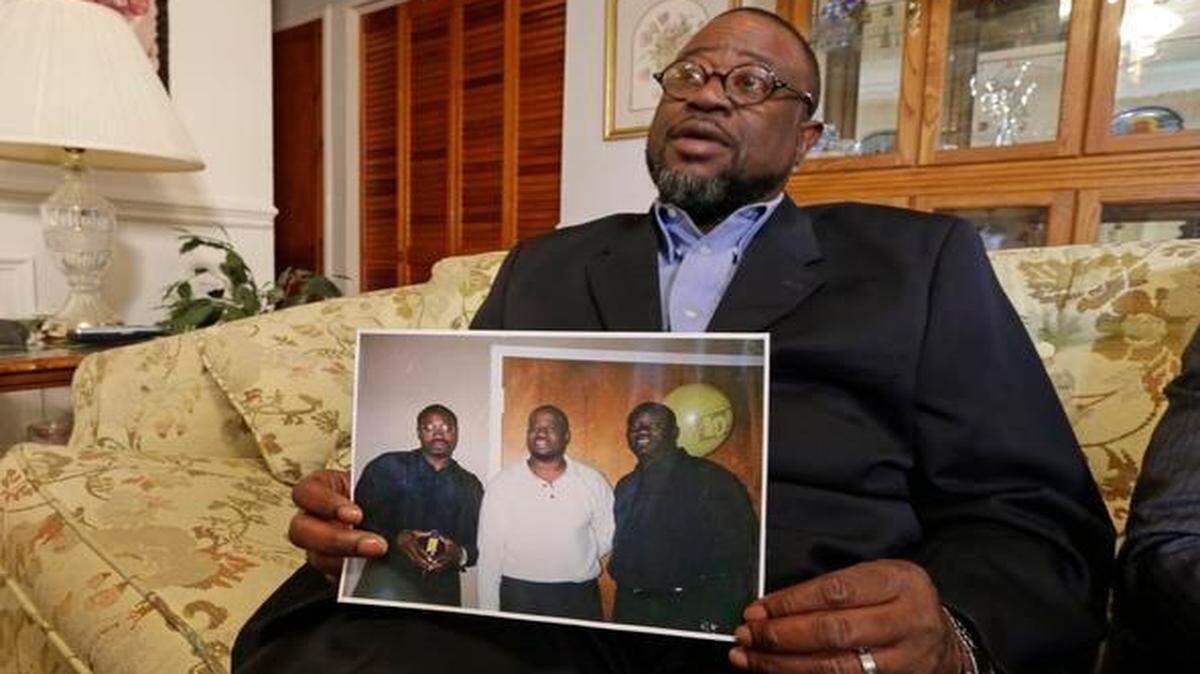 
Anthony Scott holds a photo of himself, center, and his brothers Walter Scott, left, and Rodney Scott, right, as he talks about his brother at his home near North Charleston, S.C., Wednesday, April 8, 2015. Walter Scott was killed by a North Charleston police officer after a traffic stop on Saturday.
