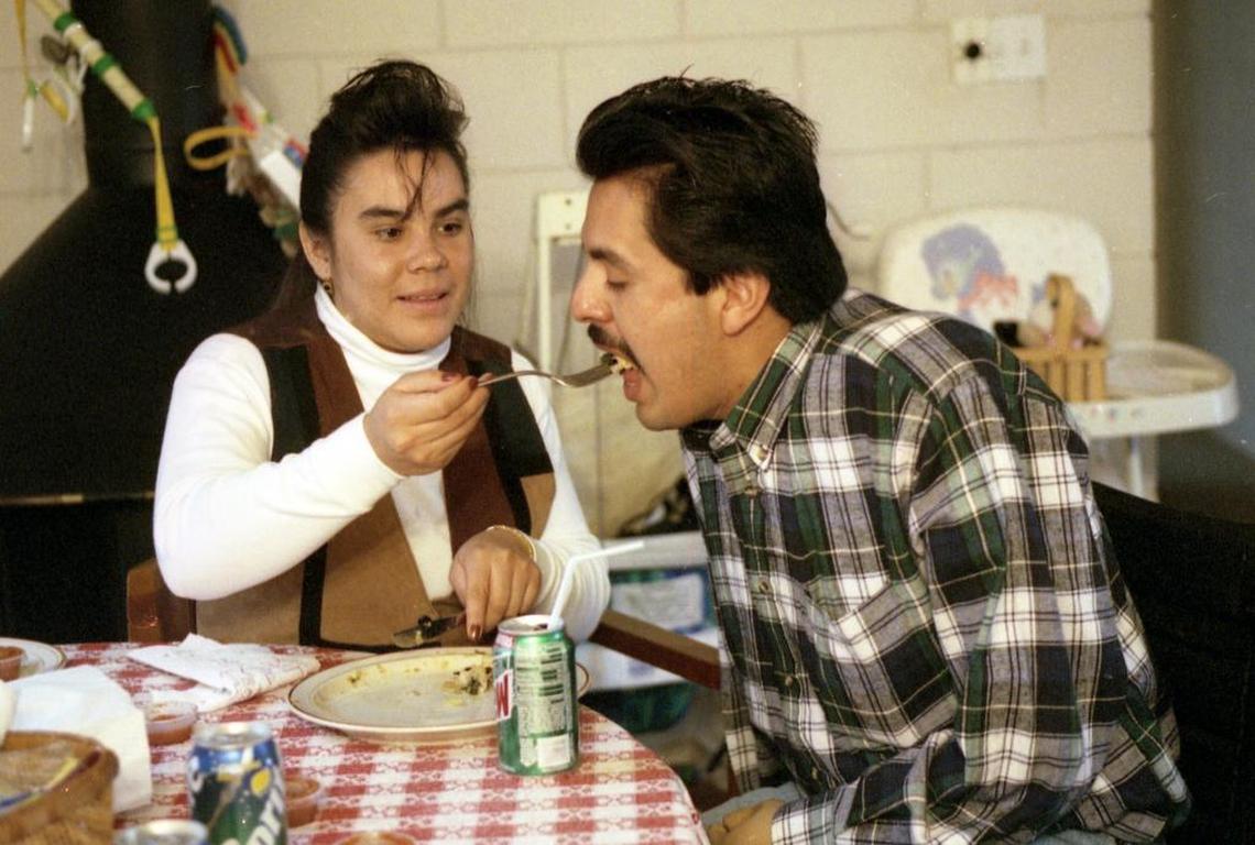 Javier Tellez Juarez’ wife, Norma, feeds him in this December 1996 photo. He lost his limbs when his shirt was caught in machinery while he dug a post hole. An artificial arm allowed him to write, paint and eat a little bit, but his wife took over feeding him most of the time. His case prompted a change in Idaho law to require that farmers to carry worker’s compensation insurance for their laborers.