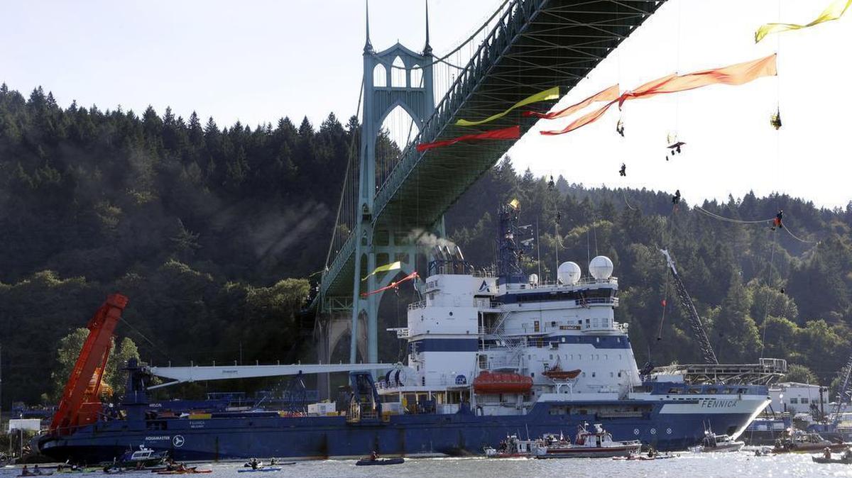 
The Royal Dutch Shell PLC icebreaker Fennica heads up the Willamette River under protesters hanging from the St. Johns Bridge on its way to Alaska in Portland, Ore., on July 30, 2015.
