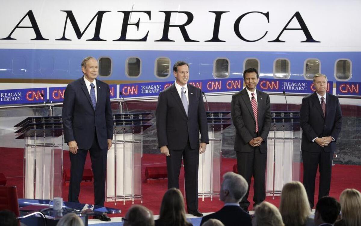 FILE: From left: George Pataki, the former governor of New York; Rick Santorum, the former senator from Pennsylvania; Gov. Bobby Jindal of Louisiana and Sen. Lindsey Graham (R-S.C.) take the stage for the earlier of two debates for Republican presidential hopefuls, at the Ronald Reagan Presidential Library in Simi Valley, Calif., Sept. 16, 2015. 