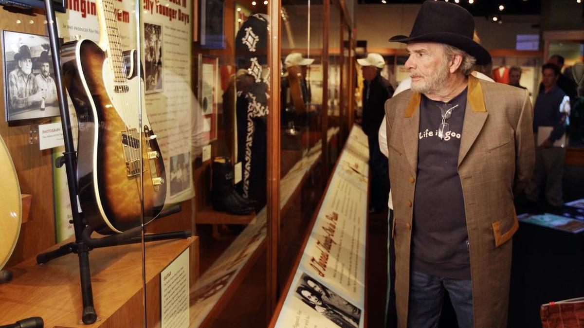 This April 10, 2012, shows Merle Haggard viewing an exhibit on the Bakersfield sound at the Country Music Hall of Fame and Museum in Nashville, Tenn.