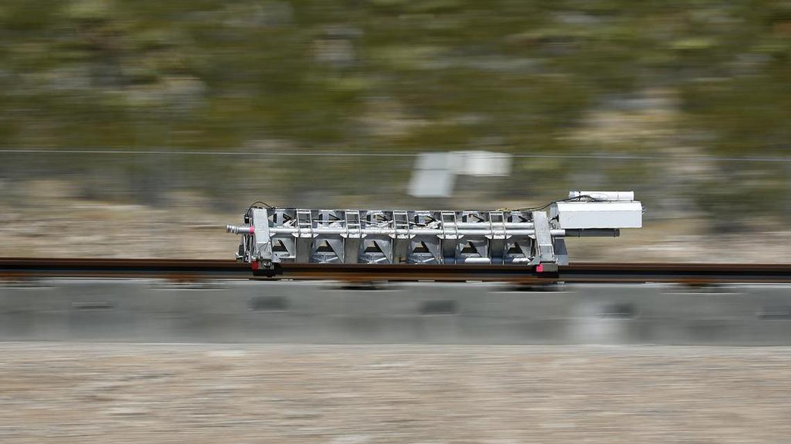 A sled speeds down a track during a test of a Hyperloop One propulsion system, Wednesday, May 11, 2016, in outside Las Vegas. The startup company opened its test site for the first public demonstration of technology for a super-speed, tube based transportation system.