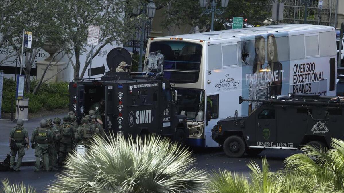 Las Vegas SWAT officers surround a bus along Las Vegas Boulevard, Saturday, March 25, 2017, in Las Vegas. Police say part of the Strip has been closed down after a shooting.