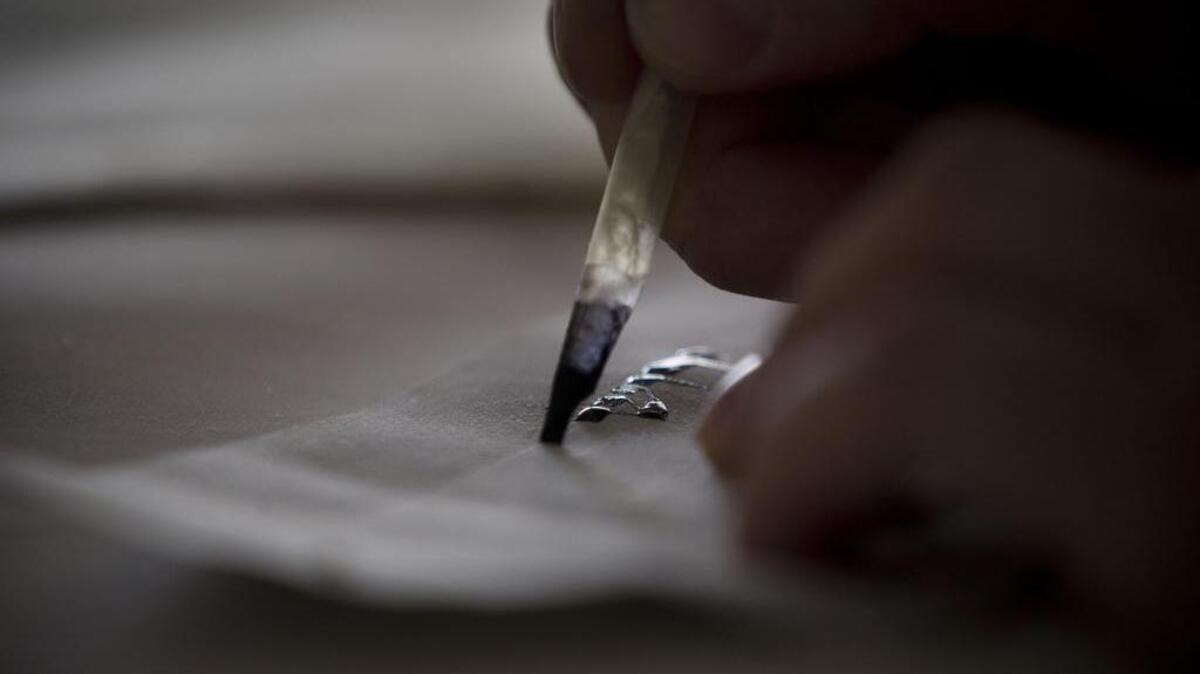 A calligrapher writes.