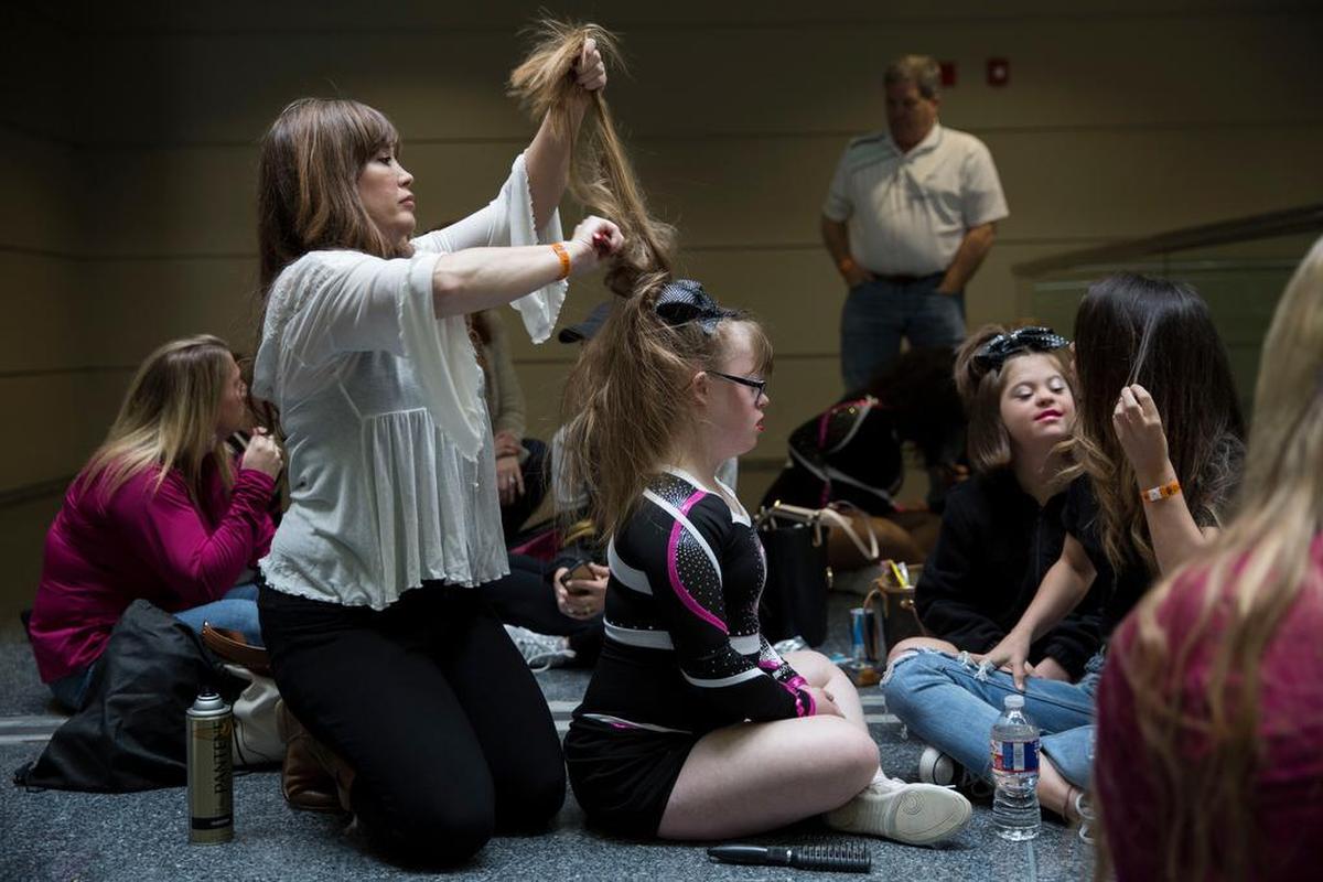 Brittany Lowe stands back stage with her team at the Dallas Convention Center waiting to compete in the NCA All-Star National Championship in the special athlete division. Lowe has been cheering on an all special needs team since age 5.