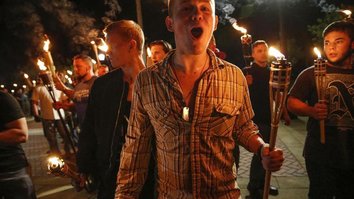 In this photo taken Friday, Aug. 11, 2017, multiple white nationalist groups march with torches through the UVA campus in Charlottesville, Va. Hundreds of people chanted, threw punches, hurled water bottles and unleashed chemical sprays on each other Saturday after violence erupted at a white nationalist rally in Virginia.