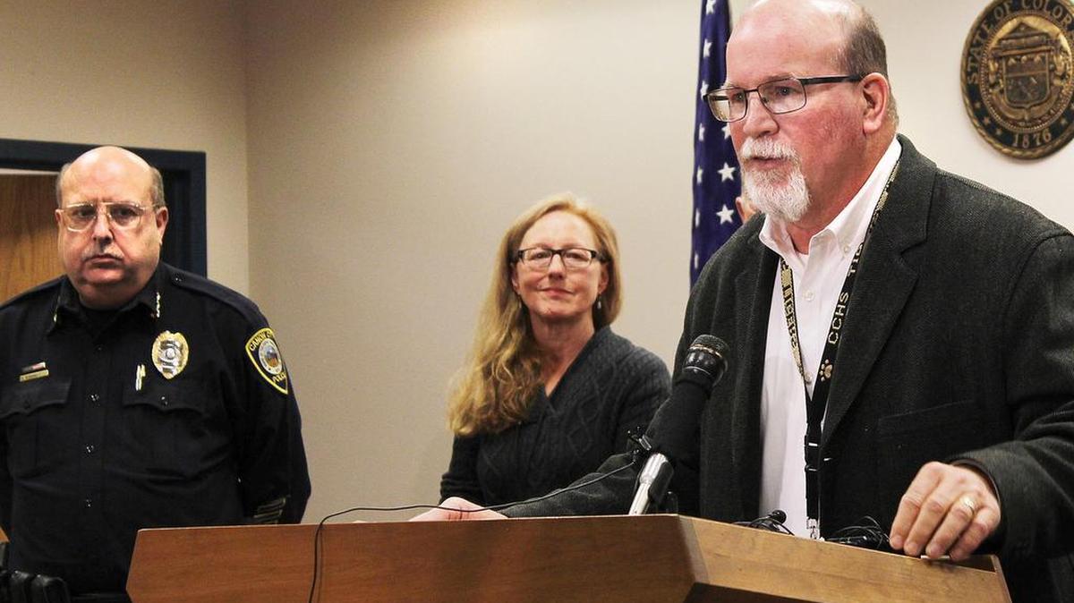 Canon City Police Chief Paul Schultz, left, and Crime Prevention Coordinator Jen O'Connor listen as Superintendent George Welsh talks about a sexting scandal at Canon City High School during a news conference in Canon City, Colo., on Friday, Nov. 6, 2015. An unspecified number of students have been suspended and the school forfeited its final football game of the season because of the number of players involved.