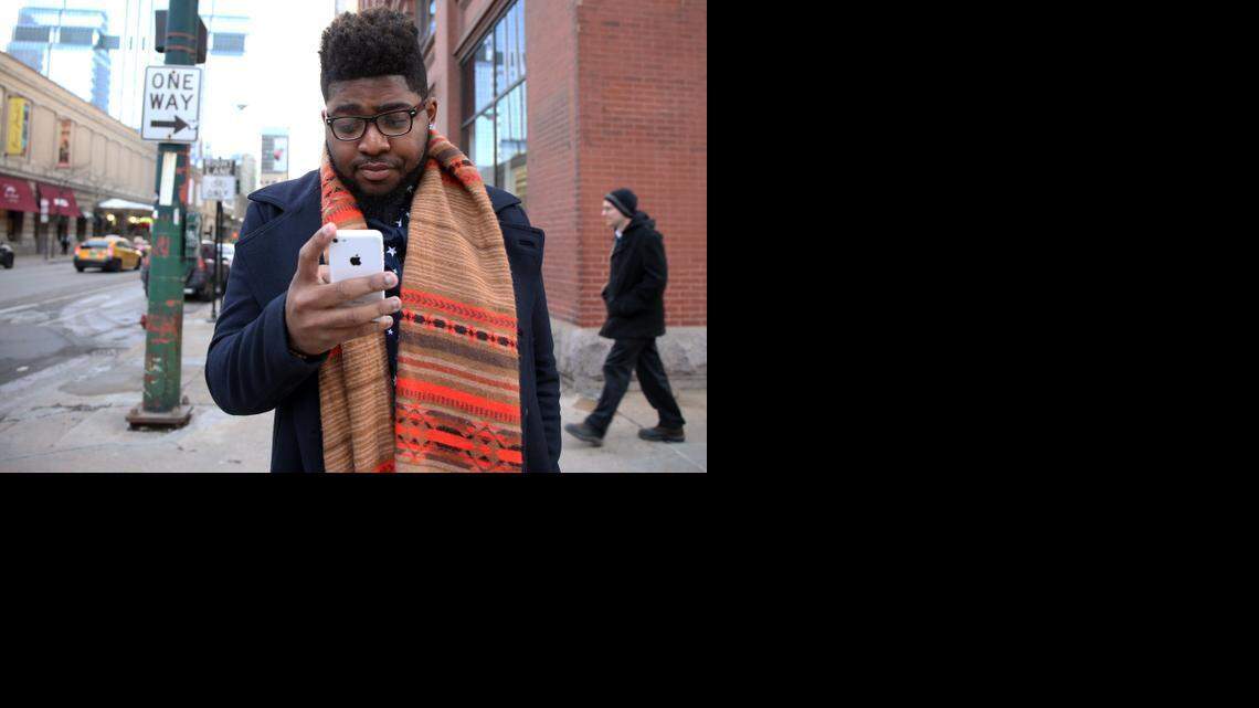 
Jeramey Winfield pauses at a traffic light as he walks to the CTA Green Line station after getting some career coaching at Career Transitions Center in Chicago on Jan. 28, 2015. It's been more than a year since he graduated from an elite private college, but he has yet to find employment. 
