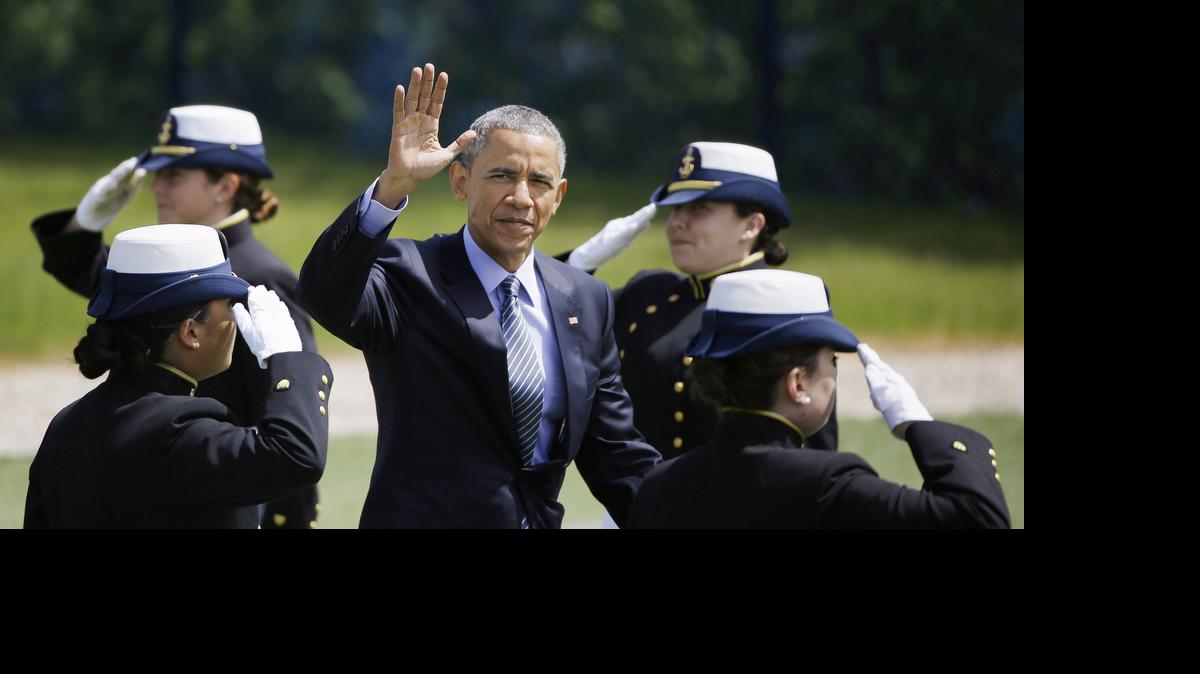 
President Barack Obama waves as he walks through a group of saluting second-year cadets as he arrives at the U.S. Coast Guard Academy's 134th Commencement Exercises, Wednesday, May 20, 2015 in New London, Conn. Obama spoke on global warming during his commencement address. 
