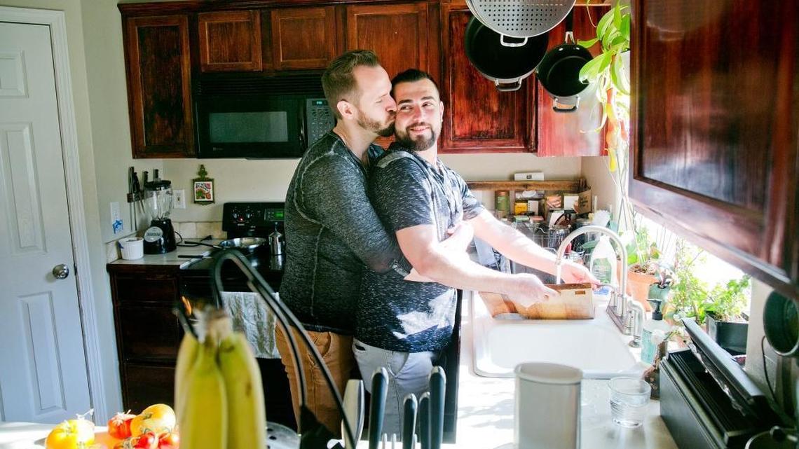 Shadi Ismail, right, gets a kiss from boyfriend Ian Guthrie while washing dishes in their home in Boise, Idaho, on Friday, Sept. 9, 2016. Ismail, a Syrian refugee, says about his new life in Boise: “I didn’t think I would be alive” to experience life in the U.S. “I wish everyone had what we have.” Despite resistance by Idaho’s top political leaders, 118 Syrian refugees have moved to the Gem State since last Oct. 1, all of them settling in Boise, according to new data from the State Department.