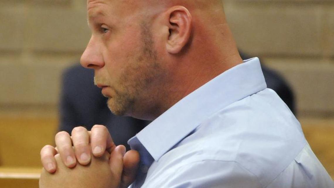Johnny Small listens as David Bollinger testifies during a hearing before Judge W. Douglas Parsons at the New Hanover County Courthouse in Wilmington, N.C. Small, convicted of committing murder when he was 15, said Monday that he could only imagine the pain the victim's family experienced, but he was unequivocal in stating his innocence.