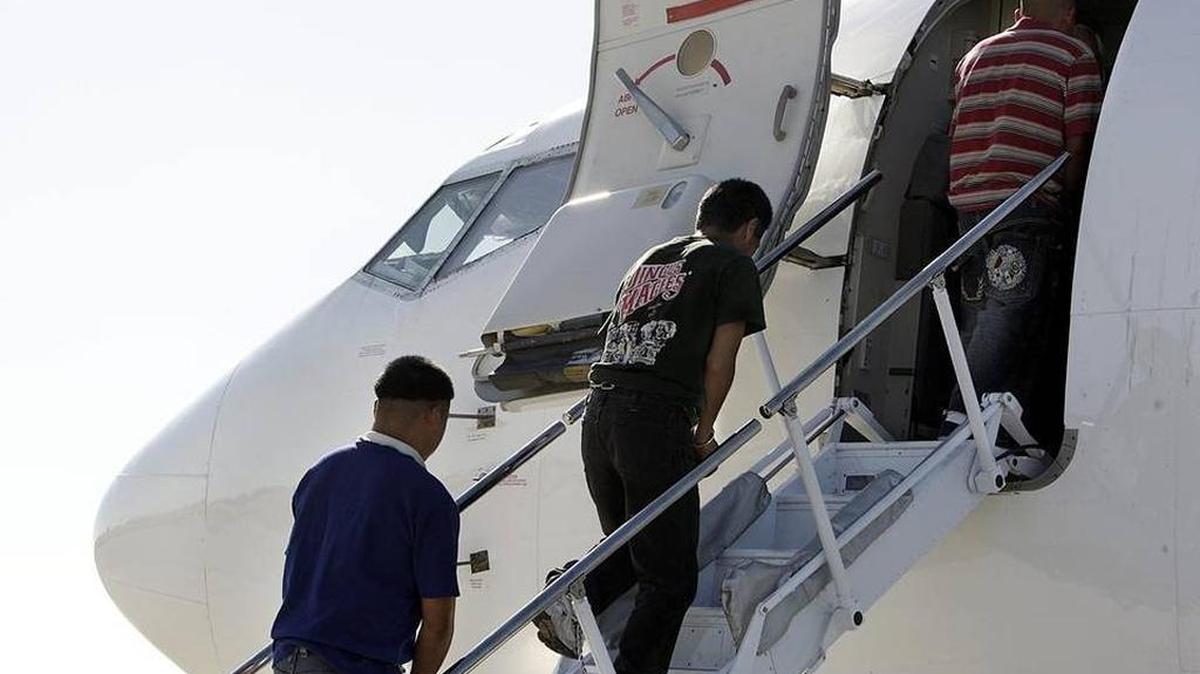 A group of undocumented Mexicans boards a plane at Miami International Airport.
