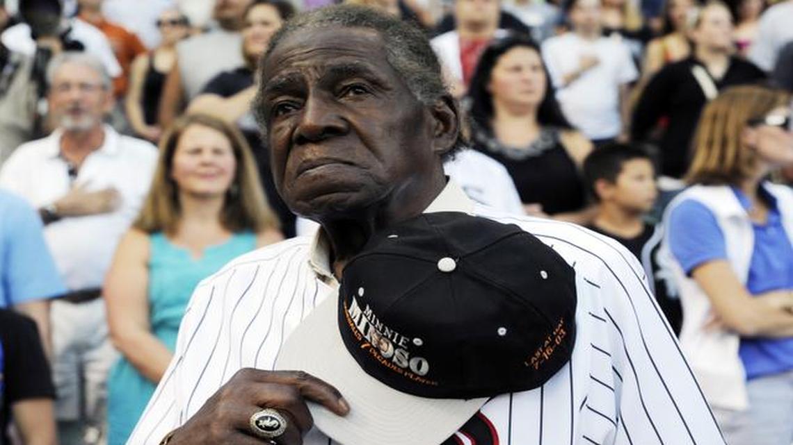
Former Chicago White Sox player Minnie Minoso stands during the national anthem before a baseball game between the Chicago White Sox and the Texas Rangers, in Chicago on Aug. 24, 2013. Minoso died Sunday, March 1, 2015. 
