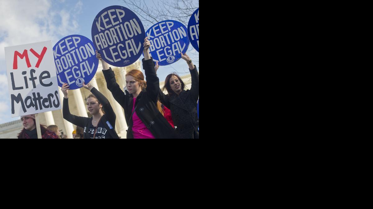 
Pro-abortion rights supporters hold up signs in front of the Supreme Court in Washington, Thursday, Jan. 22, 2015, as they wait for the arrival of anti-abortion demonstrators during the annual March for Life. Thousands of anti-abortion demonstrators gathered in Washington for an annual march to protest the Supreme Court’s landmark 1973 decision that declared a constitutional right to abortion. 
