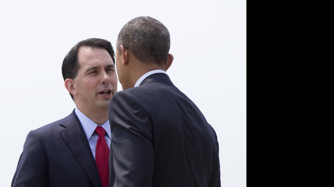 
President Barack Obama is greeted by Wisconsin Gov. Scott Walker as he arrives on Air Force One at La Crosse Regional Airport, Thursday, July 2, 2015, in La Crosse, Wis. Walker posted and soon deleted a message on his verified Twitter account Friday evening that said, “Scott Walker is running for president.” 

