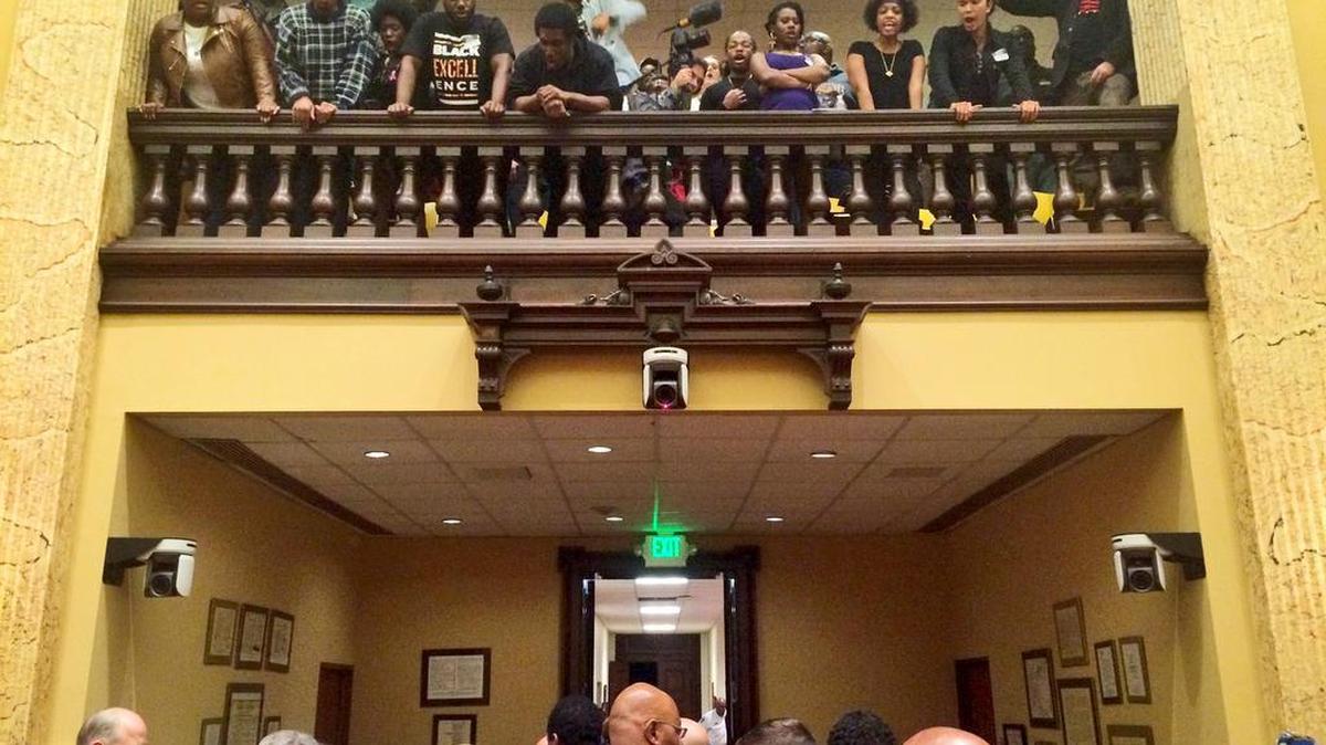 
Protesters shout as council members leave the chamber at City Hall in Baltimore, Wednesday, Oct. 14, 2015.
