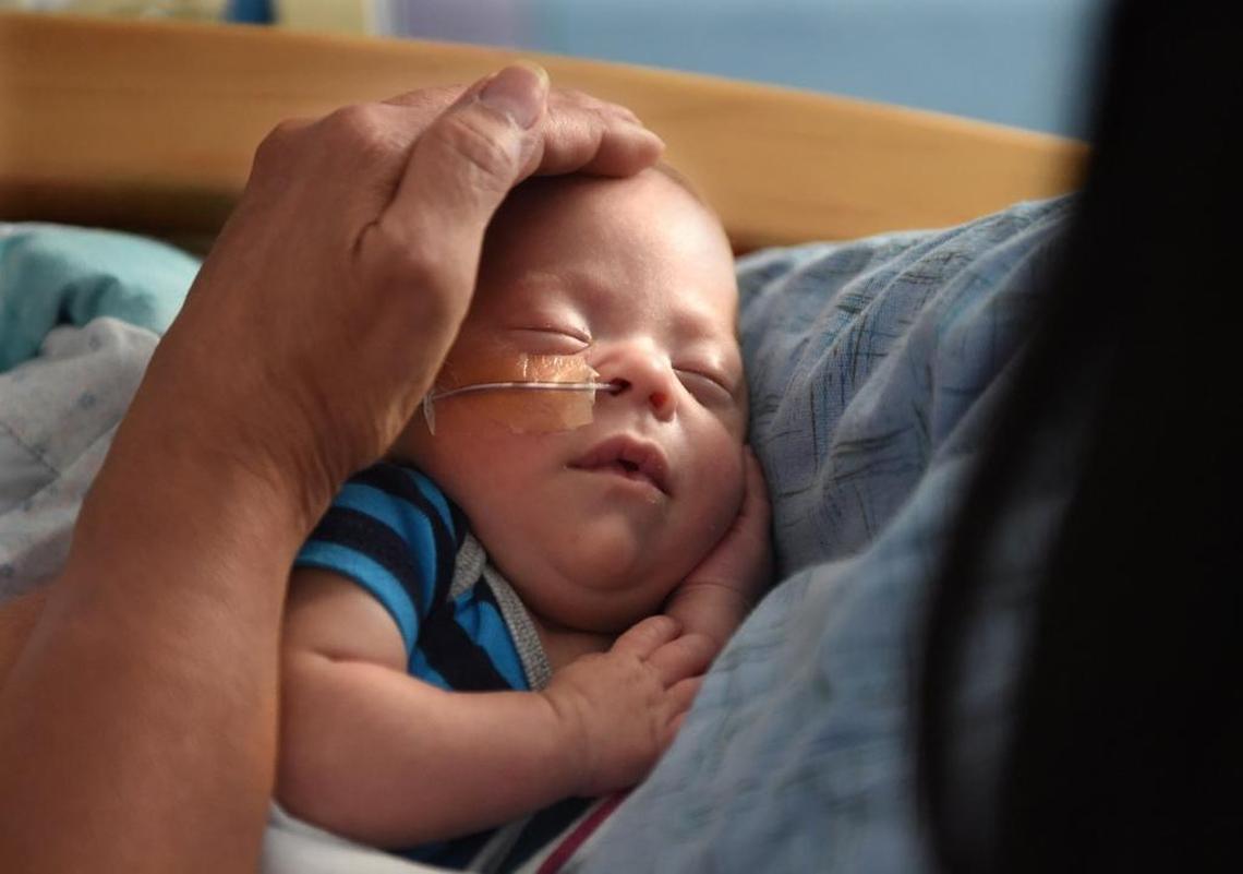 Valley Children’s Hospital volunteer cuddler Janna Lim gives a comforting touch to 3-month-old Juan Gutierrez in the neonatal intensive care unit.