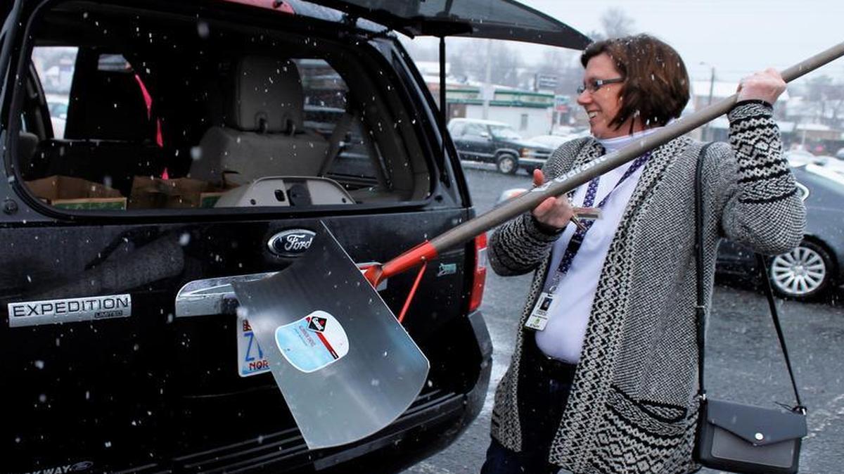 Kimberly Charles, of Winston-Salem, N.C., loads a newly purchased snow shovel into her SUV after buying it at a hardware store in Winston-Salem on Wednesday, Jan. 20, 2016.