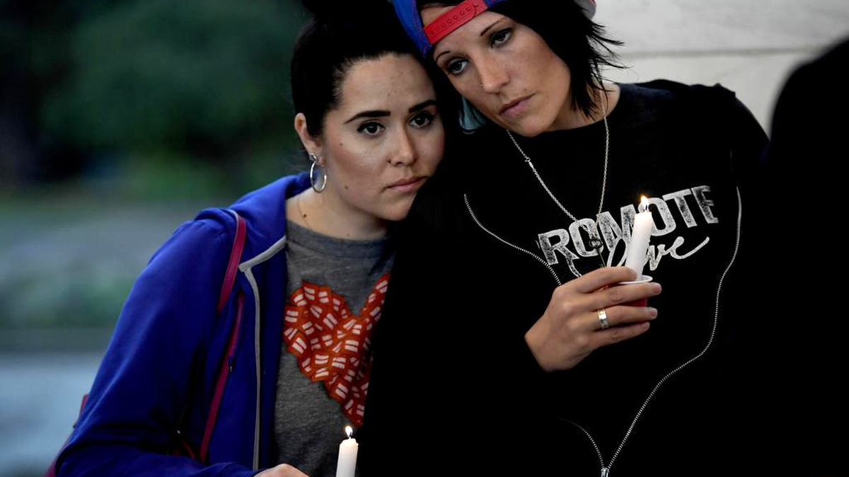 Consuelo Sidas, left, and Brooke Heise attend a PFLAG Denver chapter candle vigil at Cheeseman Park in Denver on Monday, June 13, 2016. The silent candle vigil was held in support of the tragic event at Pulse Nightclub in Orlando, Fla. More than 200 supporters attended the event.
