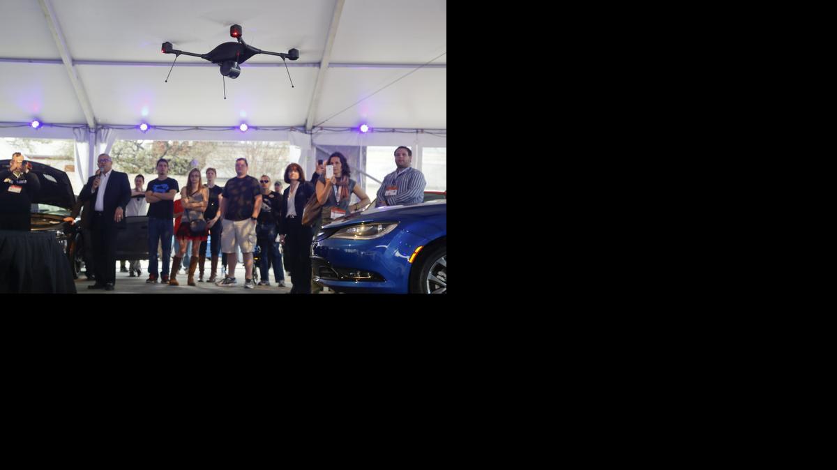 
A crowd observes an Indago drone demonstration during Tech Chat: How Drones Can Aid Transportation at the C3 Group’s Connected Car Pavilion during the SXSW Interactive Festival on Saturday, March 14, 2015 in Austin, Texas. The Indago can be equipped with a thermal camera, has a 45-minute capacity battery, auto-pilot features, a range over 5 line-of-sight miles, and can carry a payload of up to one pound. 
