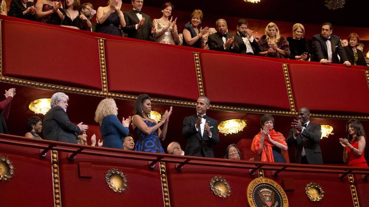 President Barack Obama, center, and first lady Michelle Obama arrive at the 2015 Kennedy Center Honors in Washington, after the president made an address to the nation, Sunday. At left are honorees filmmaker George Lucas, far left, and singer-songwriter Carole King, to the right of the president is advisor Valerie Jarrett.