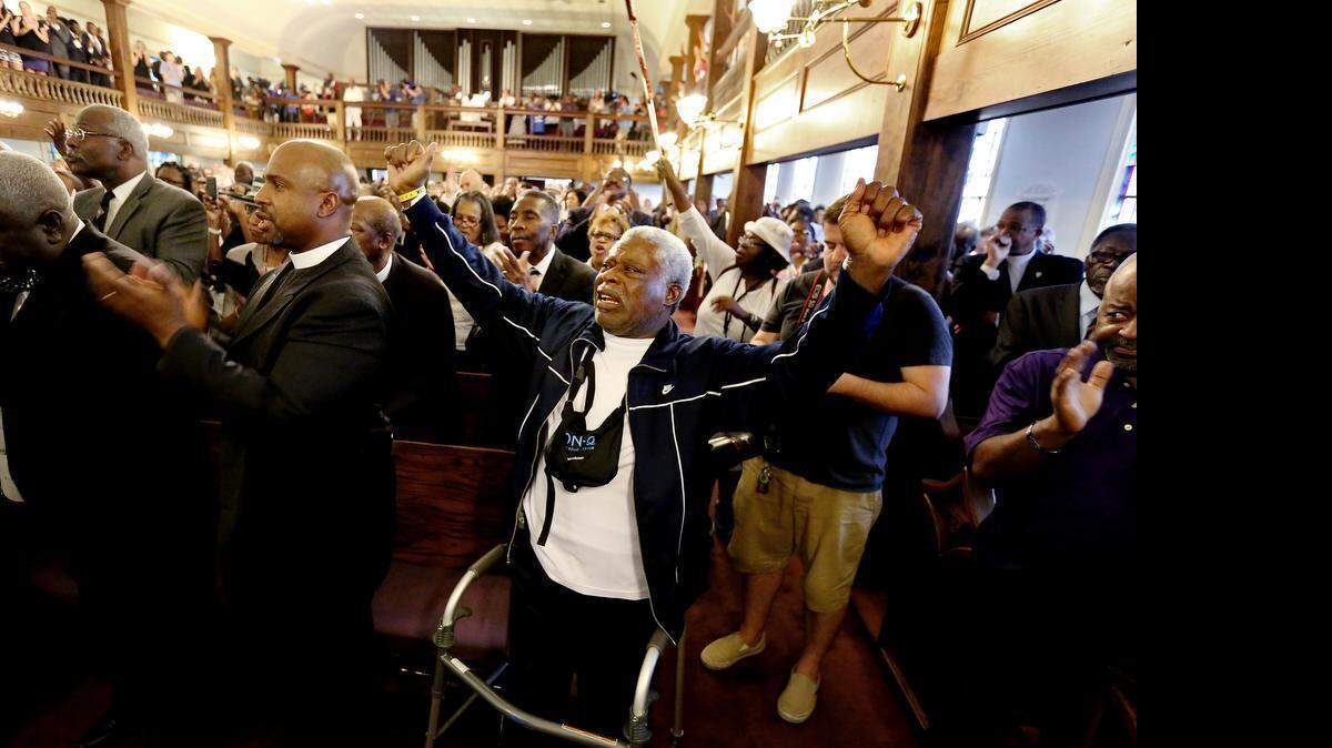 
The Rev. Sandy Drayton, reacts during a prayer vigil held at Morris Brown AME Church for the victims of Wednesday's shooting at Emanuel AME Church on Thursday, June 18, 2015 in Charleston, S.C. Dylann Storm Roof, 21, who joined a prayer meeting inside the historic black church and then fatally shot several people was captured without resistance Thursday after an all-night manhunt, Charleston's police chief said.
