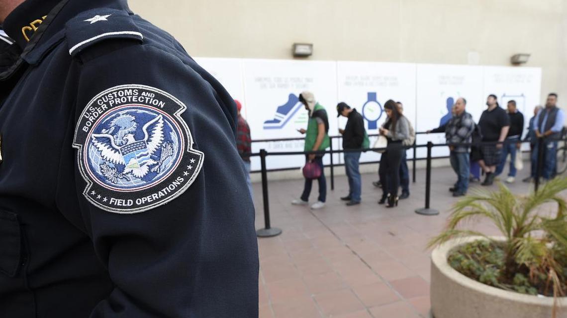 FILE - In this Dec. 10, 2015, file photo, pedestrians crossing from Mexico into the United States at the Otay Mesa Port of Entry wait in line in San Diego.
