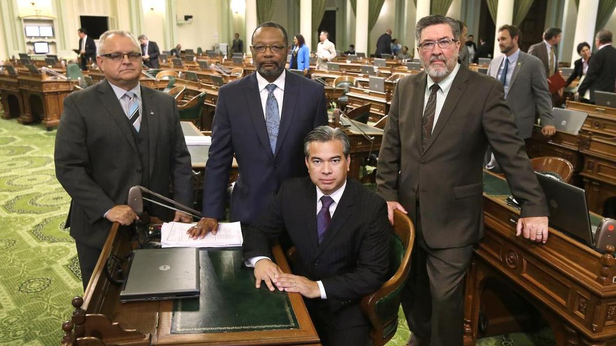 
California Assemblymen, from left, Tom Lackey, R-Palmdale, Reginald Jones-Sawyer, D-Los Angeles, Rob Bonta, D-Oakland, and Ken Cooley, D-Rancho Cordova, pose for a photo at the Capitol in Sacramento, Calif., on Aug. 20, 2015. California lawmakers voted on Sept. 11, 2015, for a proposal to create the first regulatory framework for the state's thriving but unruly medical marijuana industry after lawmakers reached an 11th-hour compromise on a trio of marijuana bills.
