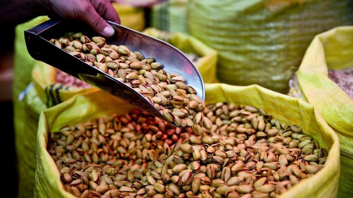In this March 31, 2013, file photo, a shopkeeper sells pistachios in western Tehran, Iran.