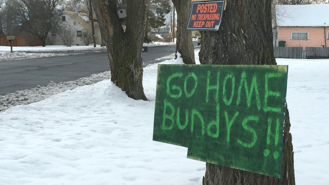 A sign tacked outside a Burns. Ore., home reflects growing community sentiment that outsider militia aren't welcome. Self-styled patriots and militia say they are in the area to help ranchers Dwight and Steven Hammond, convicted of arson for burning federal land. The sign refers to Ammon Bundy, whose father Cliven Bundy was at the center of an armed standoff in Nevada in 2014.