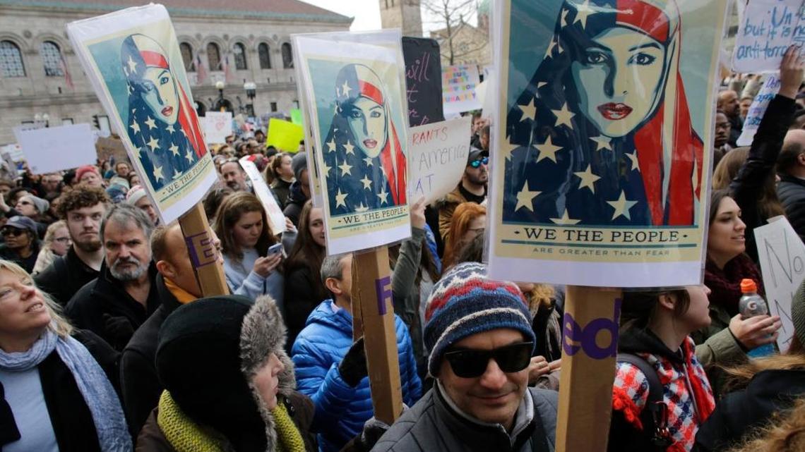Demonstrators displayed placards during a rally against President Donald Trump’s initial travel-ban executive order. The order touched off days of demonstrations across the United States.