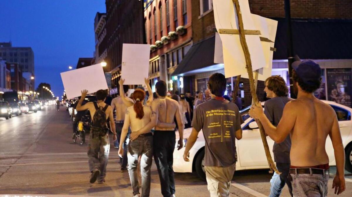 People participate in an Aug. 7 topless rally to dispute a city ordinance on exposure that requires women to cover their nipples in Springfield, Mo. Nipples can be exposed in Springfield while the American Civil Liberties Union and city leaders seek to resolve a dispute over an indecent exposure ordinance passed after the topless rally, the ACLU announced Monday.
