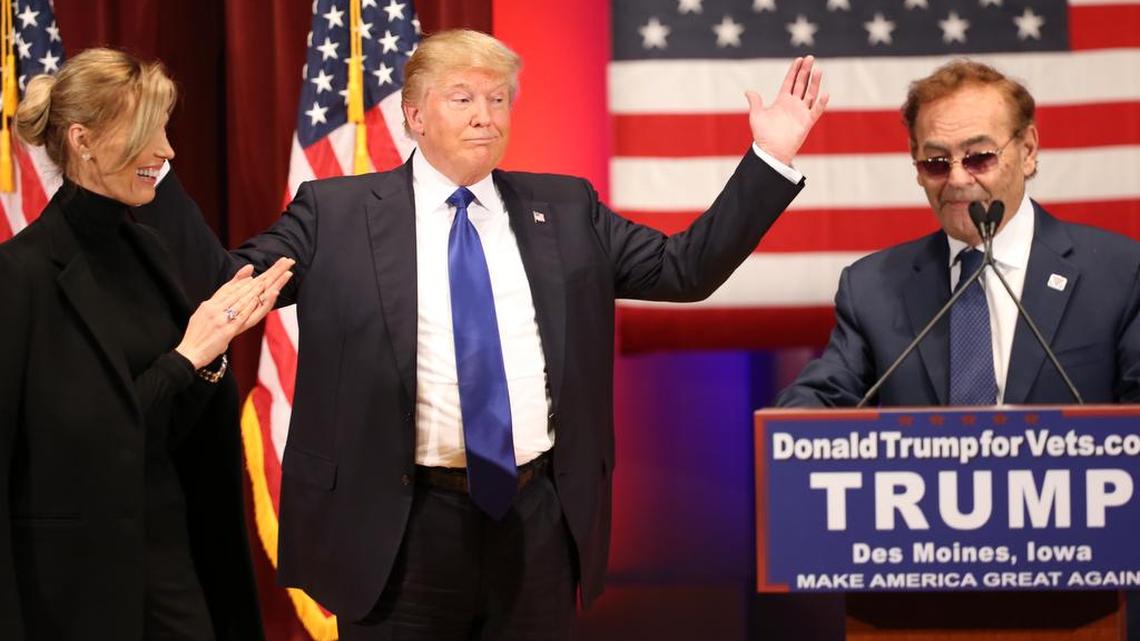 Republican presidential candidate Donald Trump listens as Treasure Island Casino owner Phil Ruffin, right, speaks at a event in support of veterans at Drake University in Des Moines, Iowa, Thursday, Jan. 28, 2016. At left is Ruffin's wife, Oleksandra Nikolayenko.