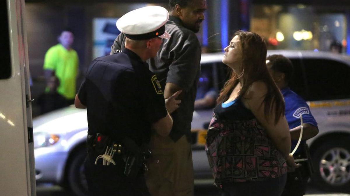 
Police arrest Damon Lynch IV, left, and an unidentified woman at Fountain Square after demonstrators marched through the streets of Cincinnati in support of Samuel DuBose, on Friday, July 31, 2015. 
