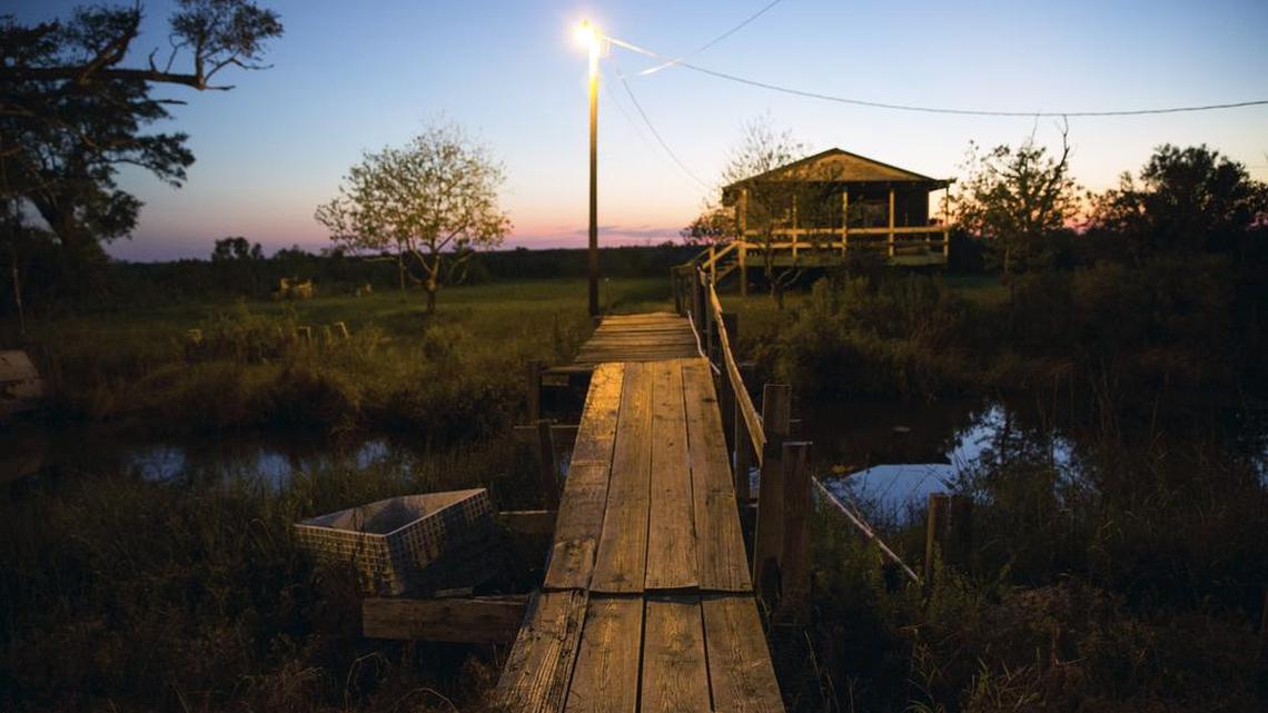 The home of Ochxia and Marq Naquin at sunset in Isle de Jean Charles, La. A $48 million grant for Isle de Jean Charles is the first allocation of federal tax dollars to move an entire community struggling with the effects of climate change.