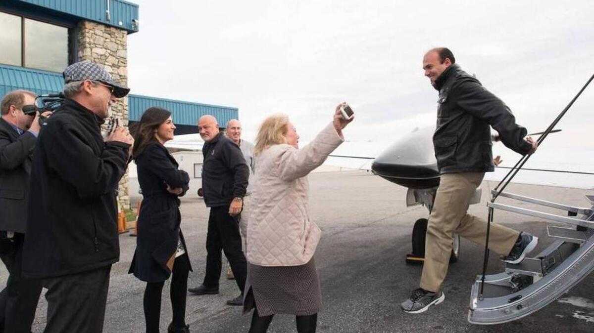 Saeed Abedini walks off a plane Thursday in Charlotte, N.C. into the arms of his mother, sister and father.