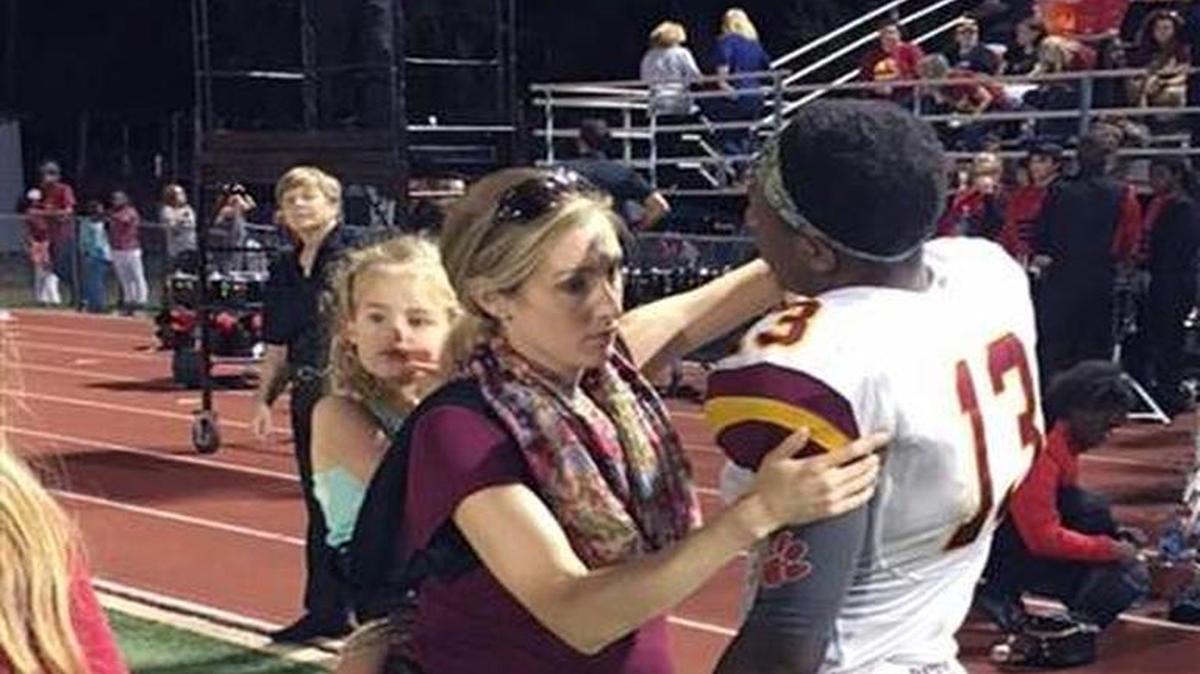 Megan Meier, who at the time was 35 weeks pregnant, was photographed on the sidelines tending to a player. Strapped to her back is her 3-year-old daughter Kate.