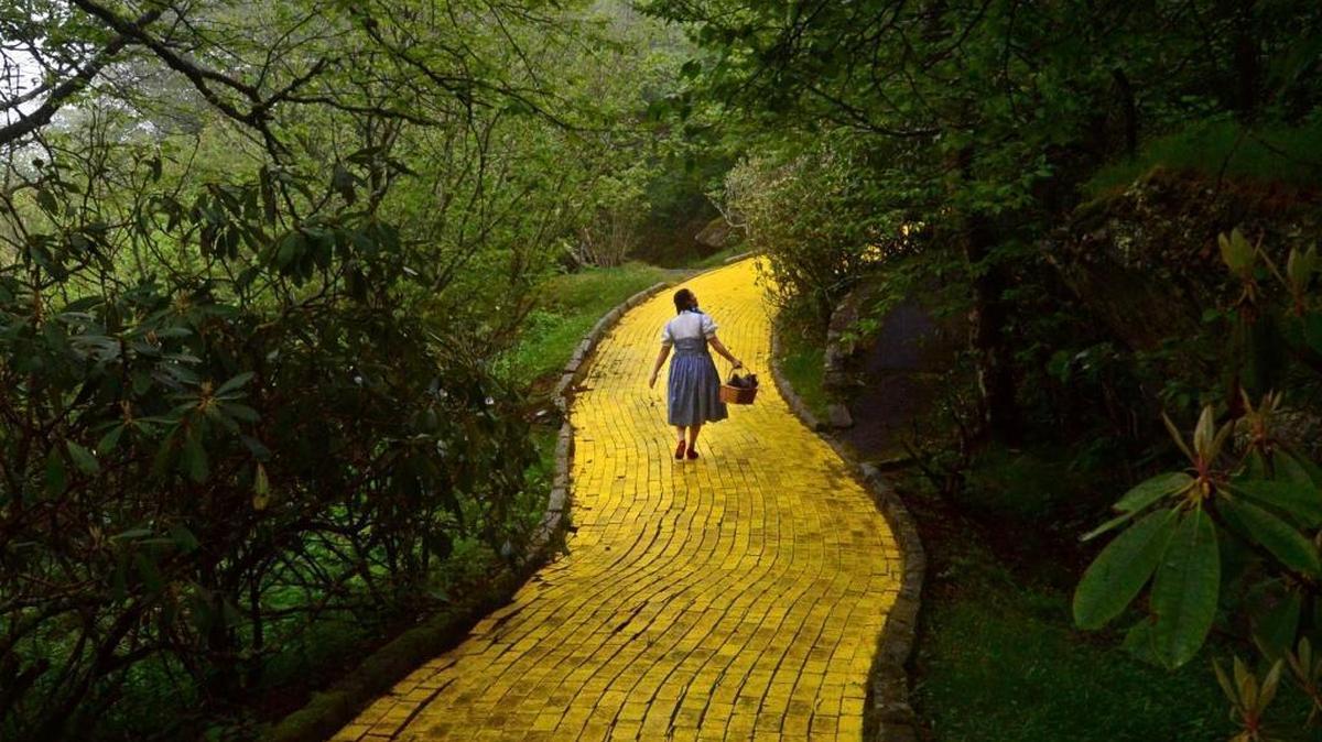 Dressed as Dorothy, Jana Greer leads a tour down the Yellow Brick Road at the Land of Oz on Beech Mountain Friday, June 5, 2015.