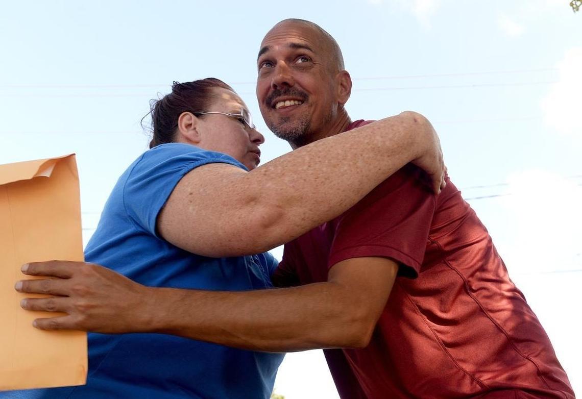 Alan Lord hugs Emily Cole, who helped him get Levi registered as an emotional support service dog in Charlotte, North Carolina.