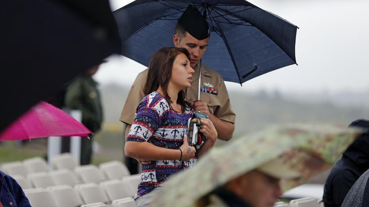 
Andrew and Angela Garrison of Johnstown, Pa., stand under an umbrella as rain falls at the dedication of the Flight 93 National Memorial Visitor Center in Shanksville, Pa, on Thursday, Sept. 10, 2015. Sitting on a hill overlooking the crash site, the $26 million visitor center complex opened to the public on Thursday, one day before the annual 9/11 observances in Pennsylvania, New York and Washington. Victims' family members got a private tour on Wednesday. 
