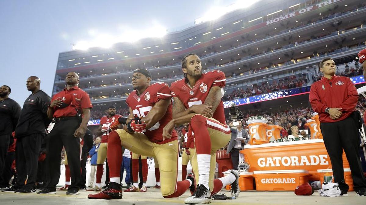 San Francisco 49ers safety Eric Reid and quarterback Colin Kaepernick kneel during the national anthem before a 2016 game. Two Washington Redskins players bougth an Xbox for a 10-year-old boy at a Virginia shop Tuesday after admiring his Kaepernick jersey.