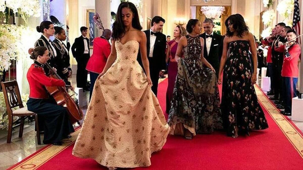Malia Obama, left, and her sister Sasha walk out of their first State Dinner with their parents. — Image Source: Official White House Photo by Pete Souza