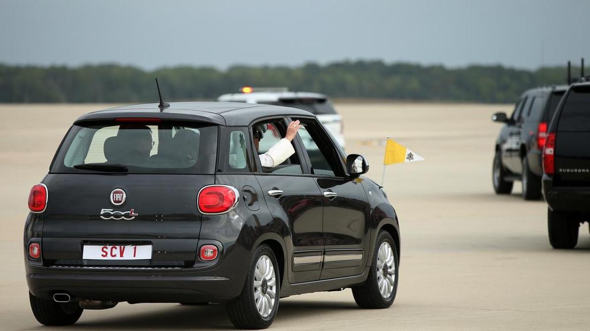
Pope Francis waves from a Fiat 500 as his motorcade departs from Andrews Air Force Base, Md., Tuesday, Sept. 22, 2015. 
