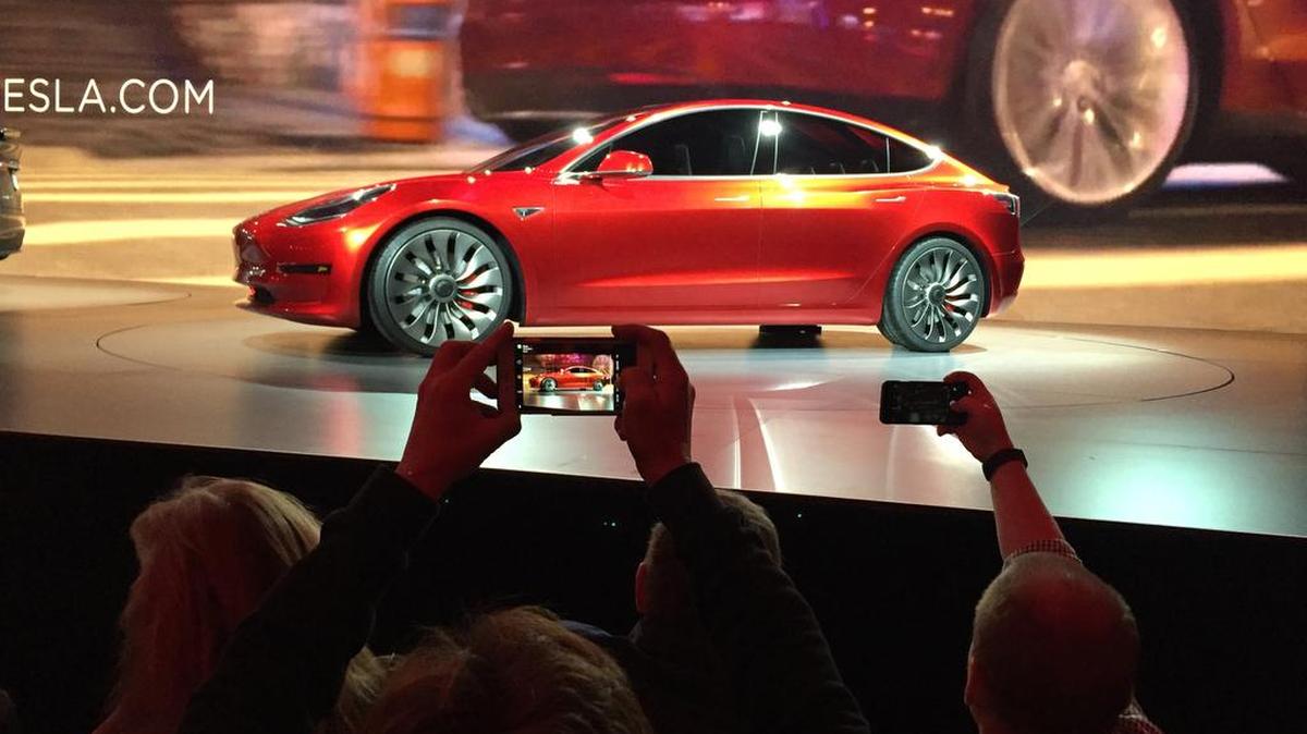 Tesla Motors unveils the new lower-priced Model 3 sedan at the Tesla Motors design studio in California on March 31. It doesn't go on sale until late 2017, but in the first 24 hours that order banks were open, Tesla said it had more than 115,000 reservations. Buyers put down a $1,000 deposit to reserve the car.