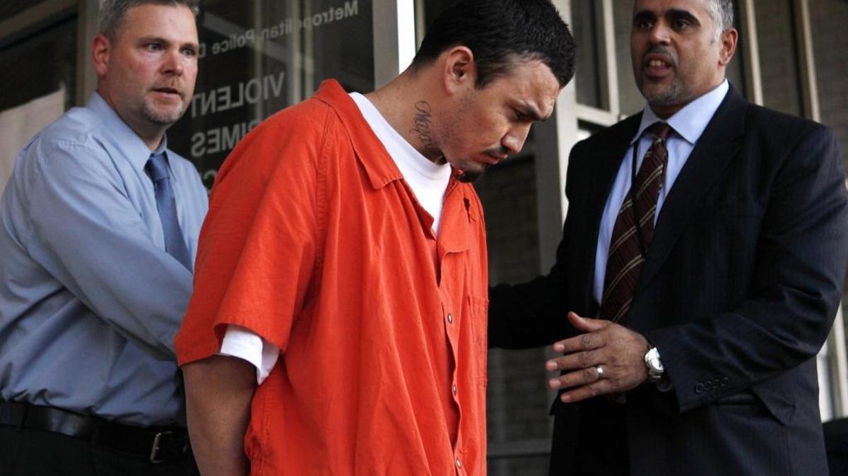 In this April 22, 2009, photo, Ingmar Guandique is escorted from the Violent Crimes Unit in Washington. A judge has set a new trial date for a man convicted of killing Washington intern Chandra Levy.