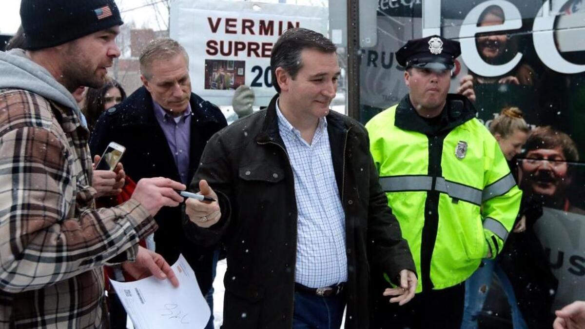 Republican presidential candidate, Sen. Ted Cruz, R-Texas, (center) walks toward his bus after a campaign event, Monday in Manchester, N.H. Progress Texas, a liberal group, filed a complaint Monday with the Texas Attorney General's Consumer Protection Division over what it said was a deceptive Cruz mailer and the Texas Democratic Party weighed in saying Cruz’s campaign was tricking Texas voters.