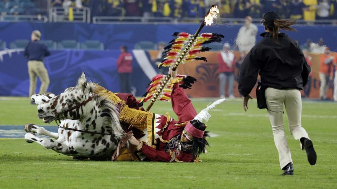 The Florida State mascot Osceola falls from the horse during a pre-game festivity before the first half of the Orange Bowl NCAA college football game against Michigan, Friday, Dec. 30, 2016, in Miami Gardens, Fla.