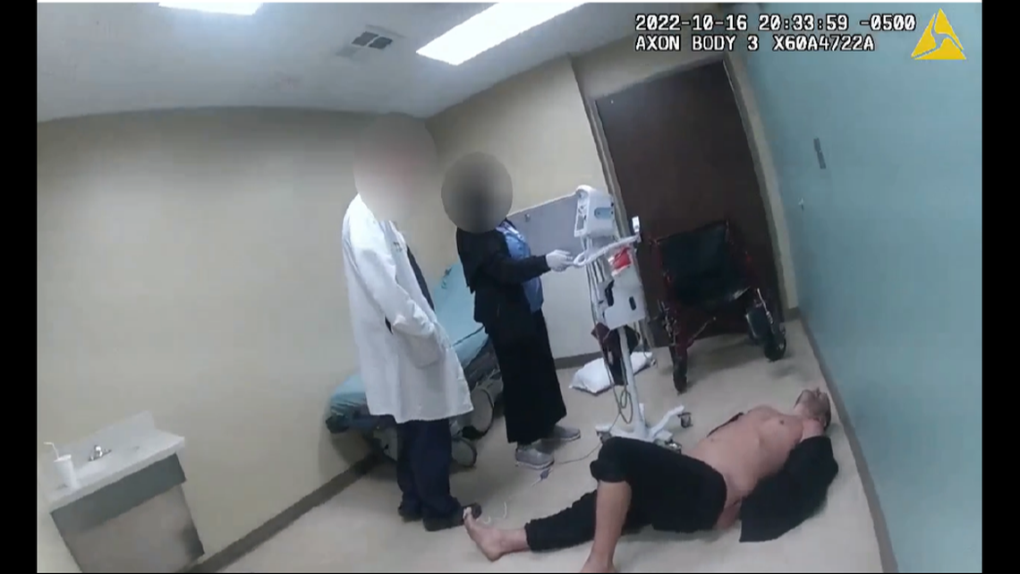 Nickolas Daniel Norberg lying on hospital room floor.