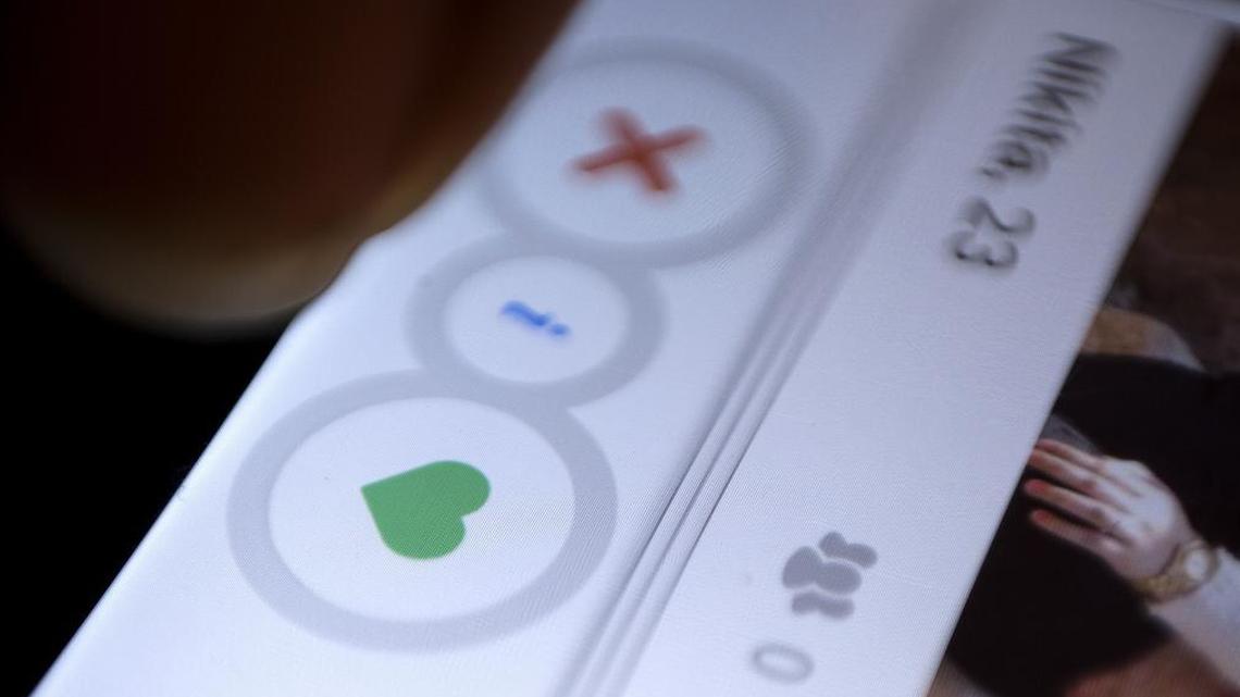 In this July 5, 2015, file photo, a man uses the dating app Tinder in New Delhi.