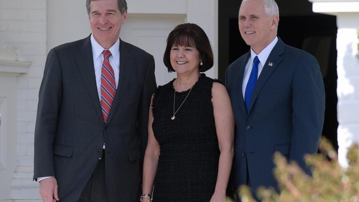 North Carolina Gov. Roy Cooper, left, poses for a photo with Vice President Mike Pence, right, and his wife Karen Pence, as he arrives for a luncheon with other governors at the Naval Observatory in Washington, Friday, Feb. 24, 2017.